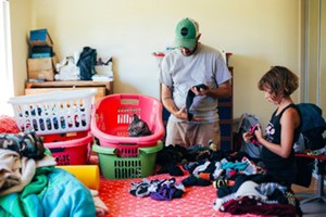 father and daughter doing laundry