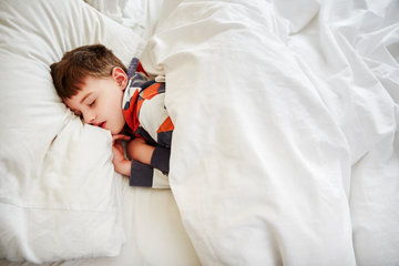 boy laying in bed