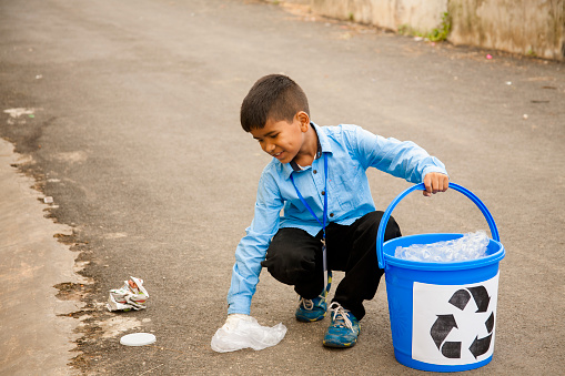 child picking up trash