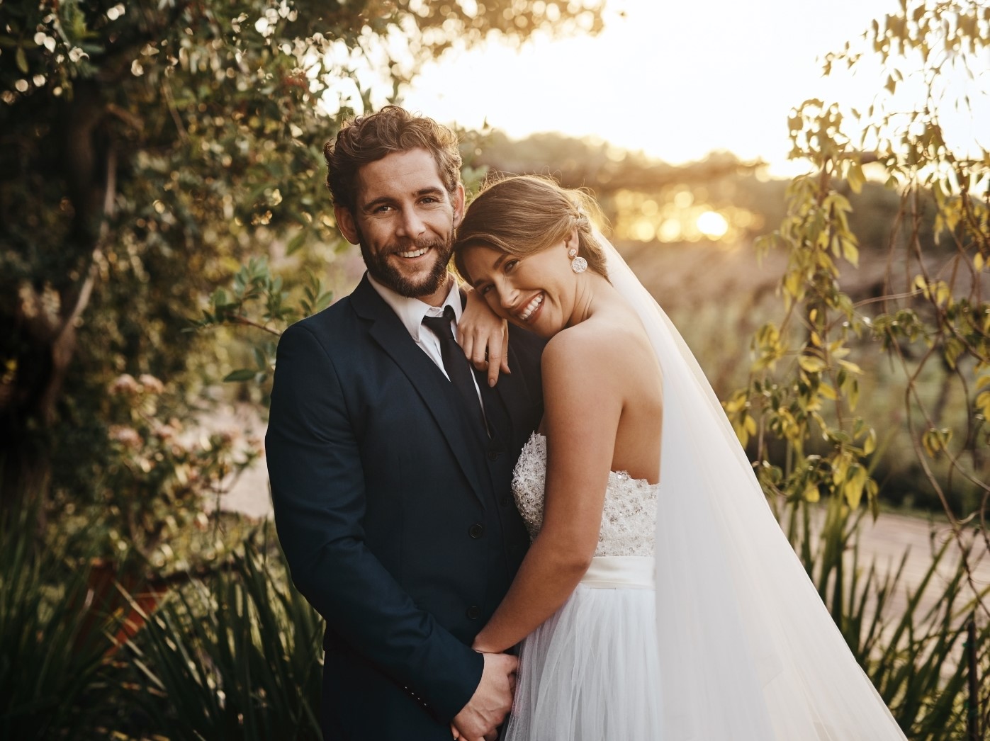 Happy bride and groom at their wedding smiling at the camera